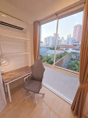a room with a chair and a desk and a window at Crane nest 10 banana farm view in Bangkok