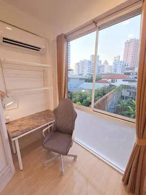 a room with a chair and a desk and a large window at Crane nest 10 banana farm view in Bangkok