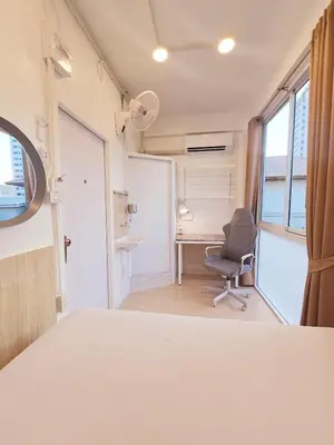 an empty room with a chair and a desk at Crane nest 10 banana farm view in Bangkok