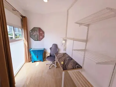 a room with a desk and a chair and shelves at Crane nest 12 mansion view in Bangkok