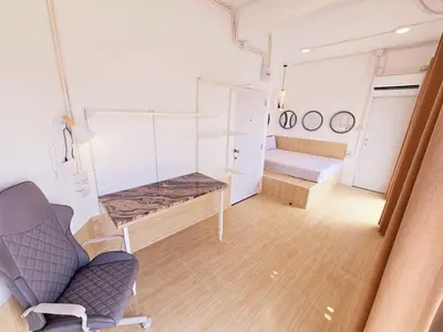 a room with a couch and a chair in a room at Crane nest 12 mansion view in Bangkok