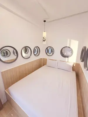 a bed in a room with four mirrors on the wall at Crane nest 13 Bangkok downtown view in Bangkok