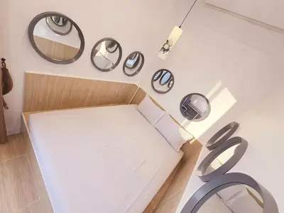 a room with a table and mirrors on the wall at Crane nest 13 Bangkok downtown view in Bangkok