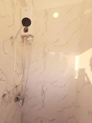 a bathroom with a white wall with drawings on it at Crane nest 13 Bangkok downtown view in Bangkok