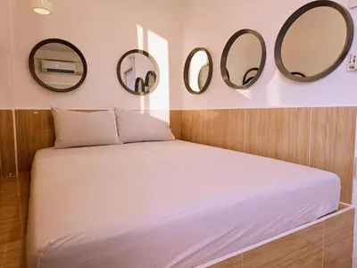 a bedroom with two mirrors above a bed at Crane nest 13 Bangkok downtown view in Bangkok