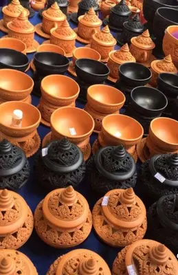 a group of cups and bowls on a table at Sabai Sabai House Koh Kret in Ban Laem Yai