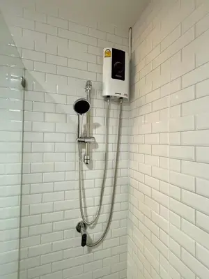 a shower in a bathroom with a shower at Luck Hotel Huai Khwang MRT Ratchada in Bangkok
