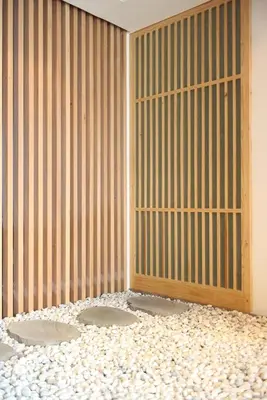 a room with a wall with a gate and gravel at Japanese Style 1-Bedroom 162m BTS Thonglor-Ekmai \u7af9 \u30ec\u30b8\u30c7\u30f3\u30b9 in Bangkok