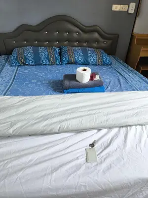 a bed with a roll of toilet paper on it at Santo house Bangkok in Bangkok