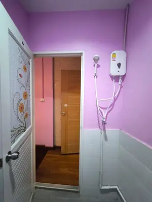 a bathroom with purple walls and a walk in shower at Santo house Bangkok in Bangkok