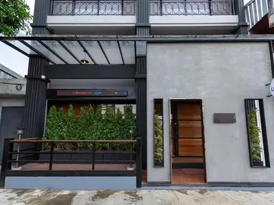 a entrance to a building with a wooden door at Sukhum Rajamangala-Phatthanakan Rooms in Bangkok