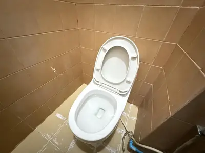 a bathroom with a white toilet in a stall at Happyland Guesthouse in Bangkok