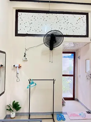 a room with a fan hanging from a wall at 212 Cozy room with private balcony in Bangkok
