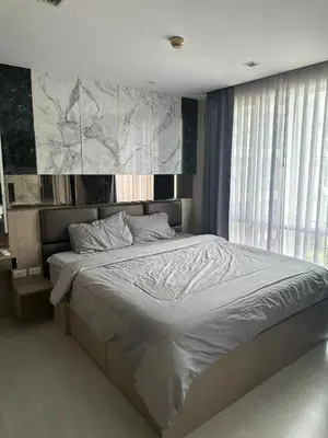 a bedroom with a large bed in a room at The Room Sukhumvit 64 Punnawithi in Phra Khanong