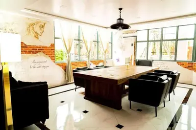 a conference room with a wooden table and chairs at Dancenter Sukhumvit 107 Bangkok Hotel in Bangkok