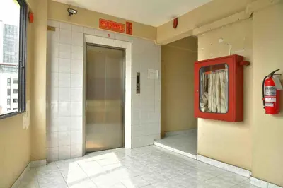 a elevator in a building with a red door at Petch Tower Ekamai Budget Serviced Apartments in Bangkok