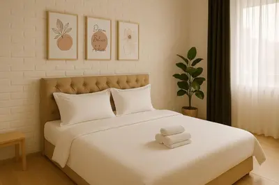 a bedroom with a bed with two towels on it at 3BR max 9pax near MRT Ratchada Good for group in Bangkok