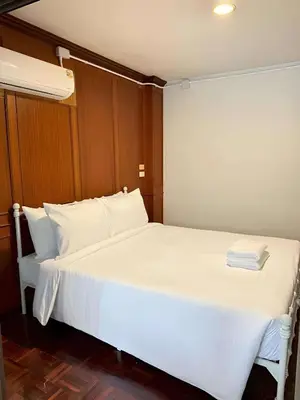 a bedroom with a bed with white sheets and pillows at XX Stay On Sukhumvit 11 - สเตย์ออน สุขุมวิท ซอย 11 in Bangkok