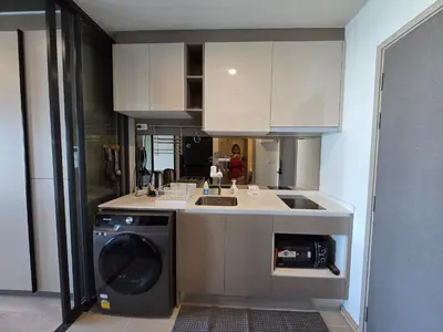 a kitchen with a sink and a washing machine at Fully equipped Ideo Rama9-Asoke, with workstation in Bangkok