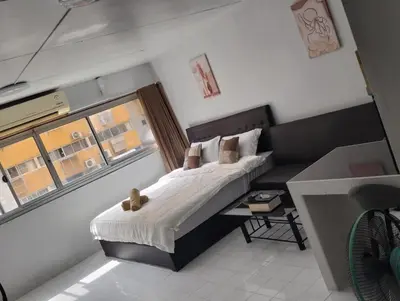 a small bedroom with a bed and a couch at แม่น้องรับตังค์ in Thung Si Kan