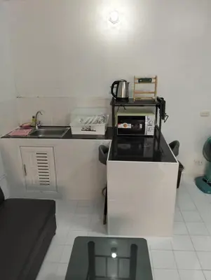 a small kitchen with a sink and a counter top at แม่น้องรับตังค์ in Thung Si Kan