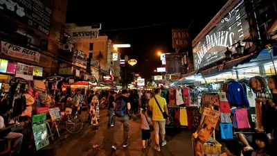 a crowd of people walking through a market at night at XX GO INN Khaosan Road BKK - โก อินน์ ถนนข้าวสาร กรุงเทพ in Bangkok