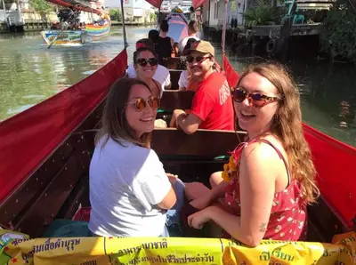 a group of people sitting in a boat on the water at Whole House - 4Bedrooms - Experience Local Life in Bangkok
