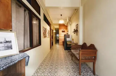 a hallway with chairs and a table in a building at Whole House - 4Bedrooms - Experience Local Life in Bangkok