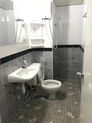 a bathroom with a toilet and a sink at Muangthongthani Rental/Khun Dan in Nonthaburi
