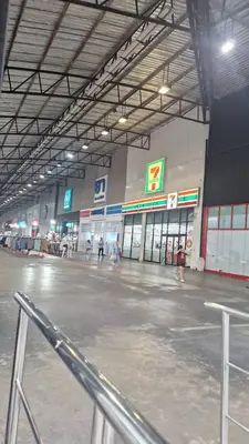 an empty parking lot with people walking around in a store at Popular Muang Thong Condo,Building 5 in Thung Si Kan