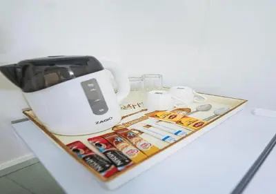 a counter top with a coffee pot and other items at RQ Timeless Dinsor Cultural Heritage House in Bangkok