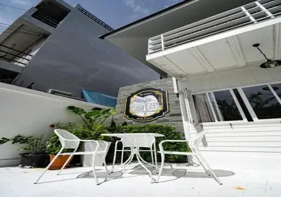 a table and chairs sitting outside of a building at RQ Timeless Dinsor Cultural Heritage House in Bangkok