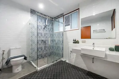 a bathroom with a shower and a toilet and a sink at MIQ S22 Pool Villa PhromPhong Emsphere 5BR in Bangkok