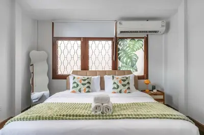 a bedroom with a bed with two towels on it at MIQ S22 Pool Villa PhromPhong Emsphere 5BR in Bangkok