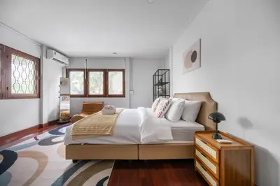 a bedroom with a bed and a dresser in it at MIQ S22 Pool Villa PhromPhong Emsphere 5BR in Bangkok