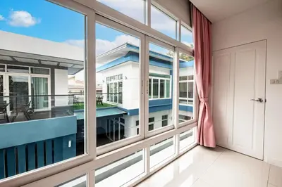 a large window in a room with a balcony at Luxury Pure Modern Pool Villa 5Bed KTV Gym Nr BTS&Central in Bangkok