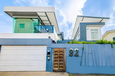 a blue and white house with a garage at Luxury Pure Modern Pool Villa 5Bed KTV Gym Nr BTS&Central in Bangkok