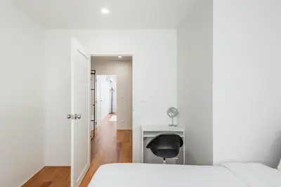 a bedroom with a desk and a chair next to a bed at The Urban478 Modern&Cozy Stay in Bangkok