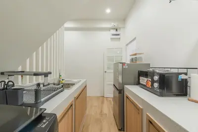 a kitchen with a refrigerator and a counter top at The Urban478 Modern&Cozy Stay in Bangkok