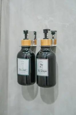a couple of bottles of liquid on a shelf at The Urban478 Modern&Cozy Stay in Bangkok