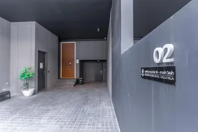 a hallway of a building with a sign on the wall at Heaven Thonglor 36 - Villa in Bangkok
