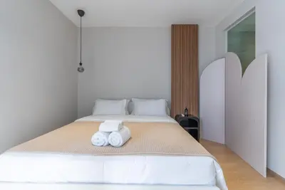 a bedroom with a bed with two towels on it at Heaven Thonglor 36 - Villa in Bangkok