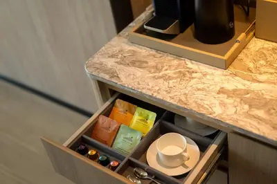 a drawer in a counter with a cup and a plate at Grand Nikko Bangkok Sathorn in Bangkok