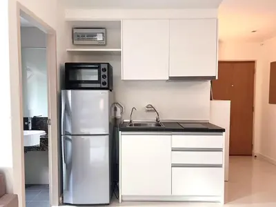 a kitchen with a refrigerator and a microwave at Best City Location with 3-min Walk to Everything in Bangkok