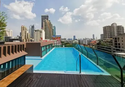 a swimming pool on the roof of a building at Best City Location with 3-min Walk to Everything in Bangkok