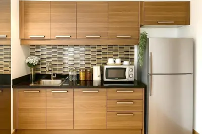 a kitchen with a microwave and a refrigerator at Spacious 2 King Beds, Balcony with View, Near Nana BTS in Bangkok