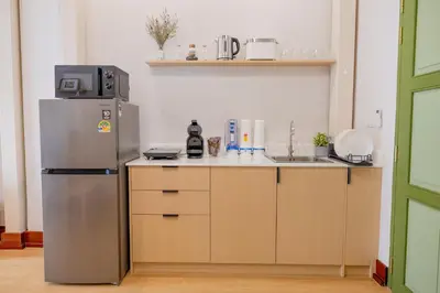 a kitchen with a refrigerator and a sink at Kraft Haus in Khlong San