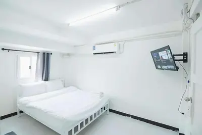 a hospital room with a bed and a tv at GO Inn Rama 3 BKK - โกอินน์ พระราม 3 in Bang Khlo