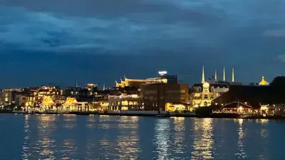 a view of a city at night from the water at Baan PadSeeEw - Rooftop Riverview 2nd floor in Thonhuri