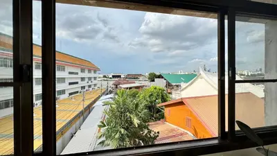 a view of a city from a window at Baan PadSeeEw - Rooftop Riverview 4th floor in Thonhuri